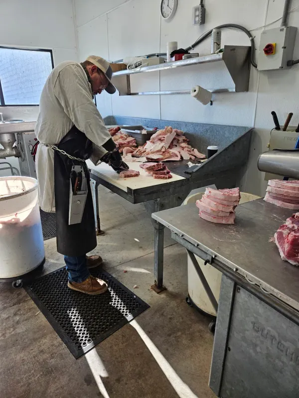 Howard Larson cutting pork